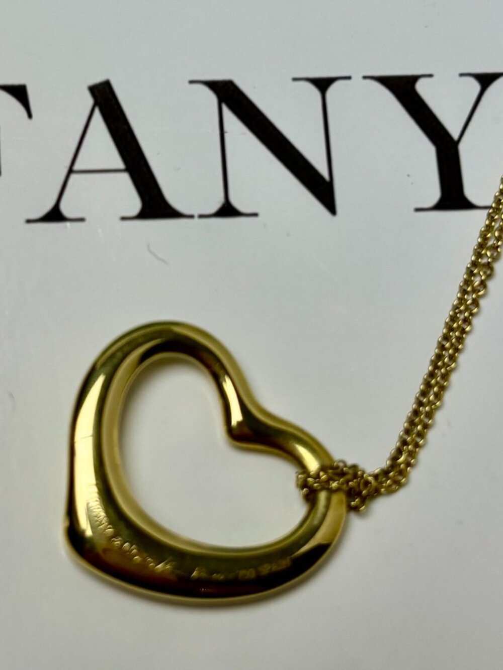 Tiffany & Co. Elsa Peretti 18KYG open heart Pendant and chain.